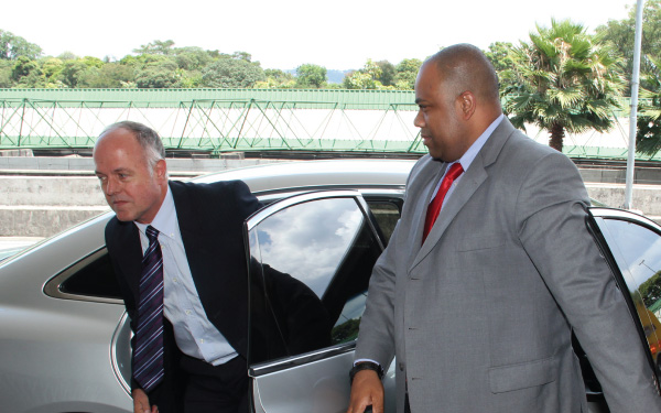 An executive protection agent escorts a vip from their vehicle.