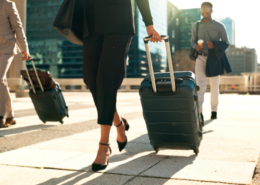 Corporate travel duty of care shown via business travellers walking to their plane.