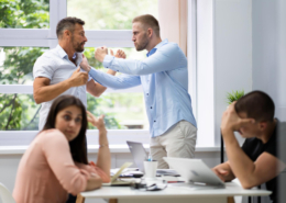 Workplace Violence Solutions shown via coworkers physically fighting.