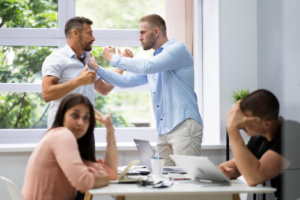 Workplace Violence Solutions shown via coworkers physically fighting. 