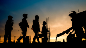 Business continuity services shown by workers entering a job site while the sun rises.