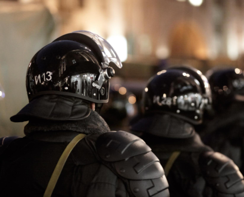 What is swatting? Shown via a small police force with helmets.